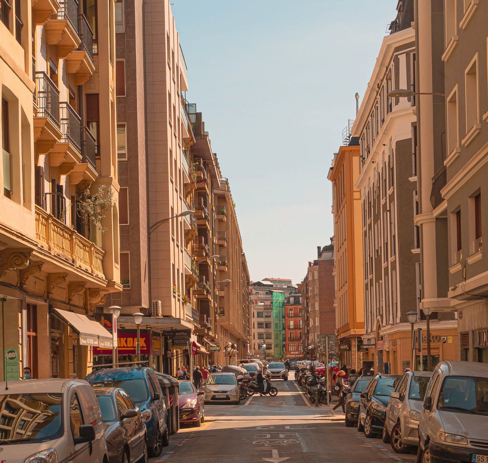 A vibrant urban street scene with bustling activity and classic European architecture.