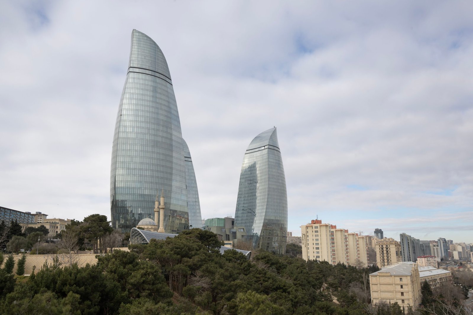 Stunning view of Baku's Flame Towers with surrounding urban park and cityscape.